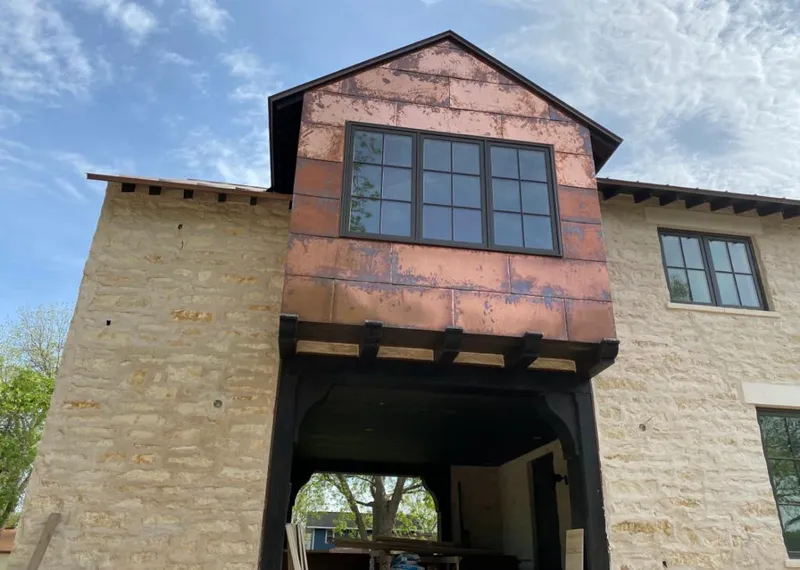 Copper metal panel facade on a stone building for Roof Repair in Stayton